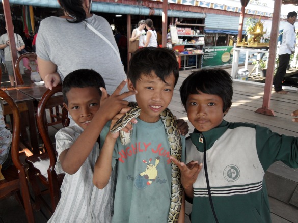 Cambodian kids holding a snake